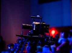 Twitch Drops Turn Game Watching Into a Software Transaction A high-quality camera setup capturing a live studio event with an audience in the background.