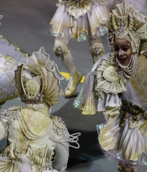 pexels-photo-15851162 Dazzling carnival performers in intricate white and gold costumes at a vibrant parade.