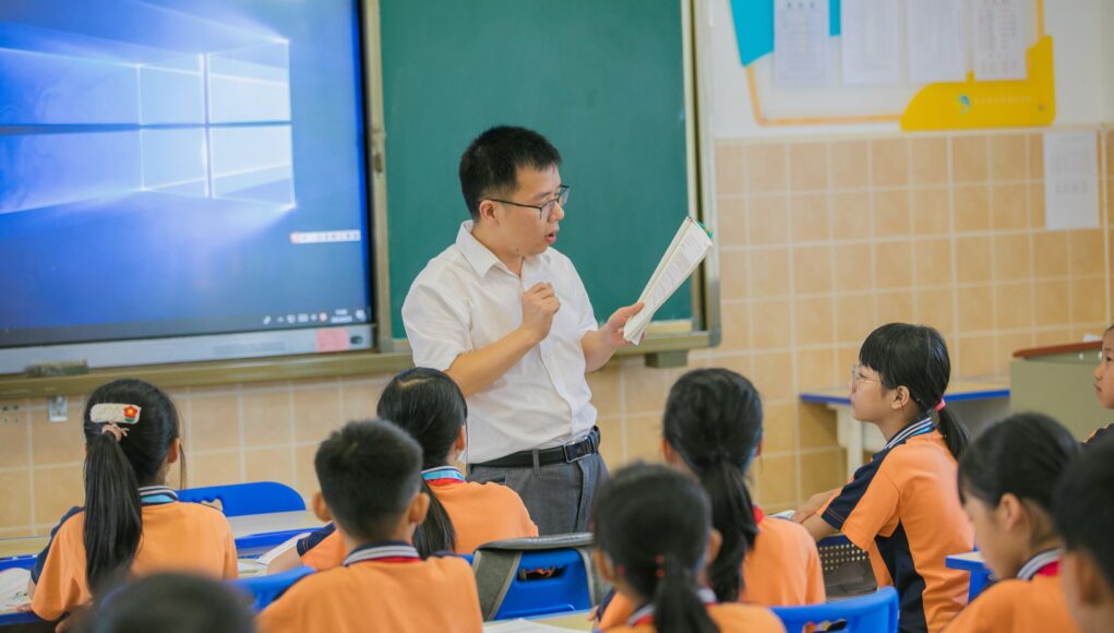 pexels-photo-18506737 Teacher instructing attentive students in a classroom setting, fostering education and learning.