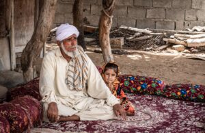 The Arabian Nights and the Medical Politics of Translation Elderly man and child sitting outdoors in traditional setting, Sistan and Baluchestan.