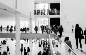 The Lucas Museum Wants Popular Images Taken Seriously. Now It Must Judge Them. A dynamic black and white image of people in a modern museum setting.