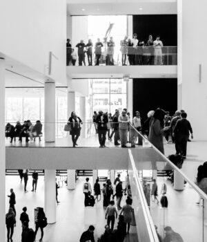 pexels-photo-36770103 A dynamic black and white image of people in a modern museum setting.