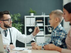 Children Can Get the COVID Vaccine. Families Still Have to Navigate the System Doctor discussing health with a mother and her child in a clinic setting.