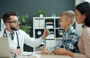 Children Can Get the COVID Vaccine. Families Still Have to Navigate the System Doctor discussing health with a mother and her child in a clinic setting.