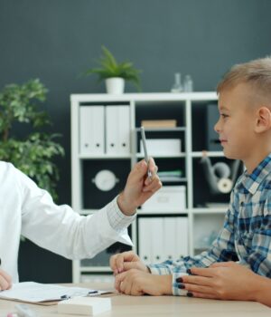 pexels-photo-39192396 Doctor discussing health with a mother and her child in a clinic setting.
