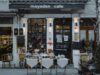 The CDFI Money Was Obligated. Small Businesses Are Still Waiting for It. An inviting outdoor café showcasing local food, menu boards, and charming decorations in a quaint neighborhood setting.