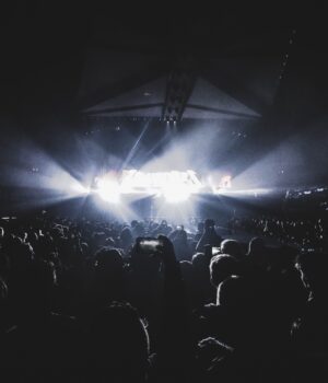 Dynamic concert scene with an energetic crowd at night in a London stadium.