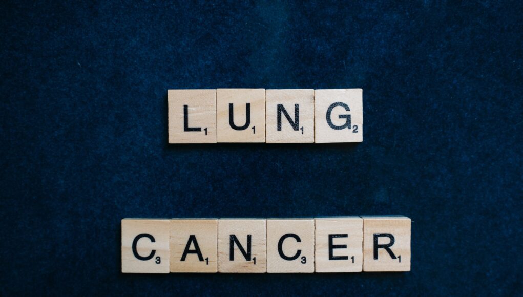 pexels-photo-8016901 Scrabble tiles spelling lung cancer on dark background symbolizing awareness.