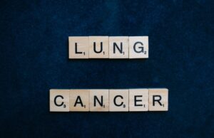 Inherited EGFR Mutation May Change How Lung-Cancer Risk Is Assessed Scrabble tiles spelling lung cancer on dark background symbolizing awareness.