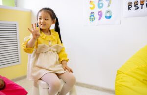 Head Start’s English-Only Proposal Could Change How Families Enter Preschool Young girl in a classroom setting learning numbers, showcasing educational activities.