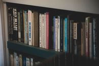 The Book Is Becoming a Collectible Before It Becomes a Classic A close-up of a bookshelf filled with diverse books on various subjects, ideal for education and study.