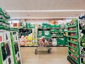 Kroger Says Cheaper Groceries Require a Smaller Corporate Office. The Savings Test Is Still Ahead. Shopping cart in a vibrant supermarket aisle in Padova, Italy.
