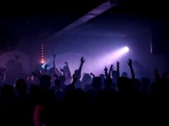 Anime Raves Are Turning Internet Fandom Into Local Nightlife Energetic crowd dancing in a lively nightclub under spotlights.