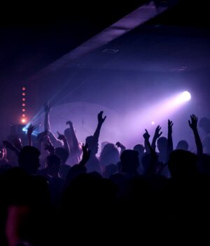 pexels-photo-5192273 Energetic crowd dancing in a lively nightclub under spotlights.