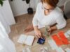 GDP Is Growing. Financial Flexibility Is Not Top view of a woman managing finances with a calculator, cash, and bills in a home setting.