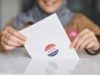 California’s Ballot Fight Is Now About Executive Pressure, Not Just Voter Eligibility Close-up of hands holding a vote ballot, symbolizing election participation.
