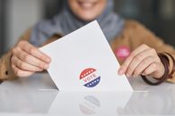 California’s Ballot Fight Is Now About Executive Pressure, Not Just Voter Eligibility Close-up of hands holding a vote ballot, symbolizing election participation.