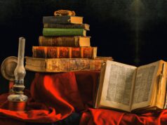 The King in Yellow and the Technology of an Imagined Future An artistic still life featuring a stack of vintage books and an olive lamp on rich red cloth.