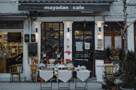 Small-Business Bankruptcy Is Rising. The Real Test Is Whether the Businesses Survive. An inviting outdoor café showcasing local food, menu boards, and charming decorations in a quaint neighborhood setting.