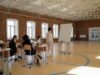 One More Year of School May Lower Dementia Risk. The Evidence Is Stronger Than Correlation—and Less Certain Than the Headline Students in school uniforms engaged in a lesson with a teacher in a spacious classroom.