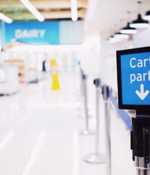 pexels-photo-7451964 Blue signboard with inscription Cart park placed near counter with products in contemporary supermarket